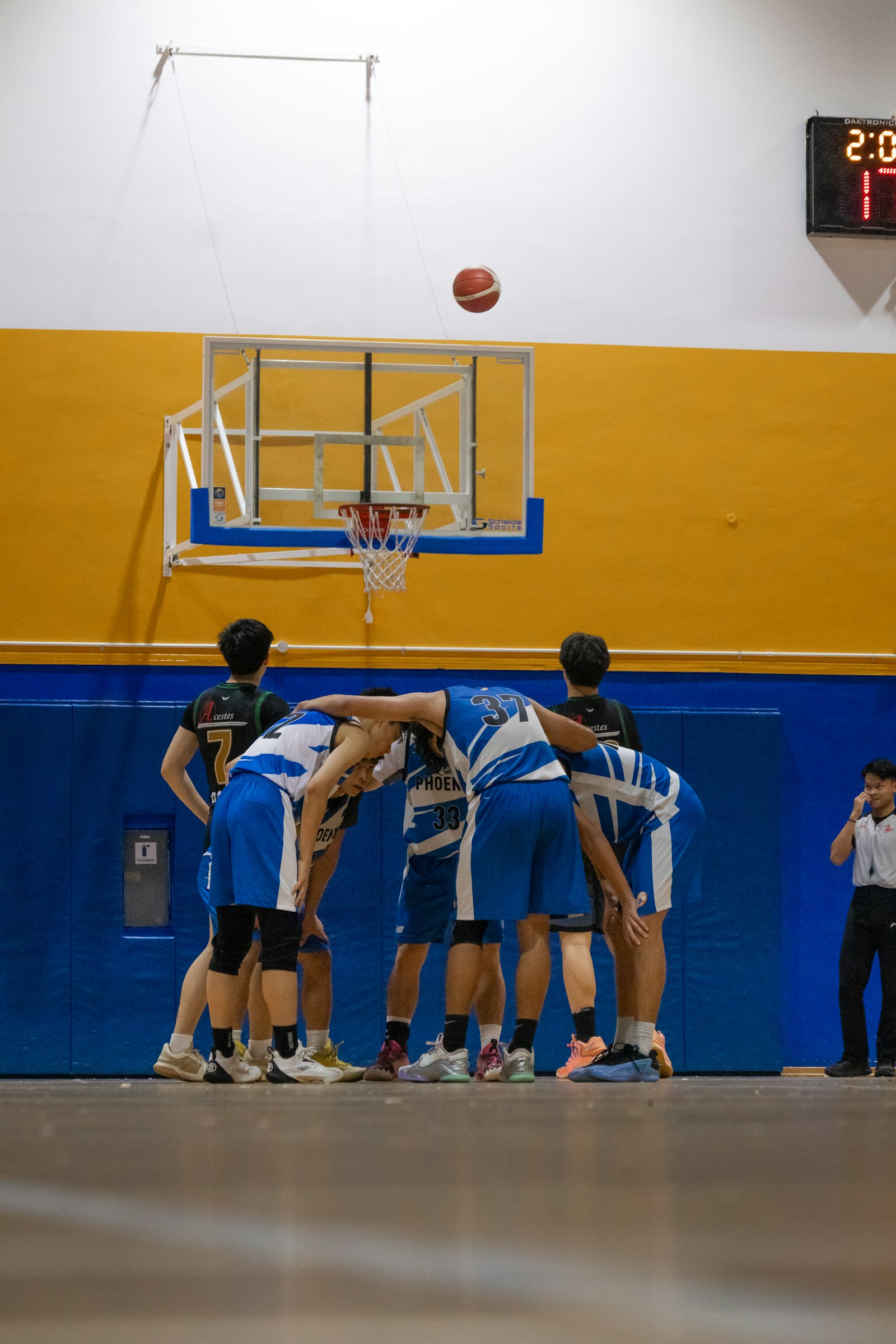 Basketball teammates leaning into a huddle before a game